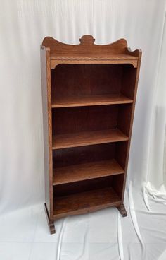 an old wooden bookcase with three shelves