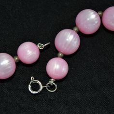 "This vintage necklace is lovely! Single stranded, it features pink moonglow plastic beads (possibly lucite), small metal bead spacers, and has a spring ring clasp. Beautiful! Measures 24.25\" from end to end. Condition : Good.. There's light wear on the beads." Vintage Pink Single Strand Jewelry, Vintage Pink Beaded Necklace With Round Beads, Vintage Pink Beaded Necklaces For Jewelry Making, Pink Polished Round Bead Necklaces, Pink Beads For Jewelry Making, Pink Vintage Beaded Necklaces With Colorful Beads, Pink Beaded Necklaces With Lobster Clasp, Pink Round Polished Bead Necklaces, Pink Round Necklace With Lobster Clasp