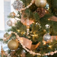 a decorated christmas tree with gold and silver ornaments