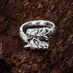 a silver ring sitting on top of a rock