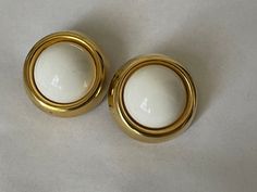 "Trifari TM white cabochon, gold plated clip-on earrings diameter - 1.5\" Very good condition marked: Trifari TM 1990-s. 000386" Formal White Clip-on Earrings, Formal Round Metal Clip-on Earrings, White Round Clip-on Earrings, White Formal Clip-on Earrings, White Vintage Clip-on Earrings For Formal Events, Retro Gold Clip-on Cabochon Earrings, Retro Round Clip-on Earrings For Formal Occasions, Vintage White Round Clip-on Earrings, Retro White Clip-on Jewelry