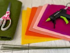 some scissors are sitting on top of different colored papers