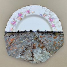 an old plate with some broken glass on it