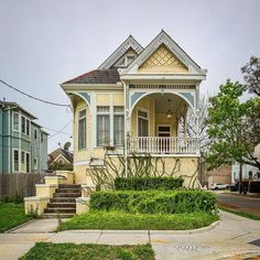 a yellow house sitting on the corner of a street