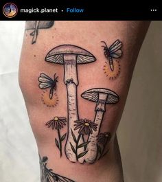 a woman's leg with tattoos on her legs and some insects flying around it