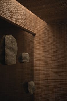 two rocks are placed on the wall next to each other