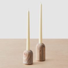 two candles sitting next to each other on a table