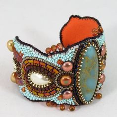 Bead Embroidered Cuff Bracelet In A Southwestern Art Nouveau Style. Features A Resin "Turquoise" Marquise Focal Point, Embellished With Assorted Glass Shapes And Pearls. Color Palette Is Turquoise Green Blue With Copper, Brown And Bronze. This One Of A Kind Bracelet Has A Metal Core Under The Beadwork, Backed With Ultrasuede. Master Quality Jewelry Handmade By A Top Contemporary Designer. Handmade Item Bracelet Length: 7 1/2 Inches; Bracelet Width: 2 1/2 Inches Materials: Copper, Glass, Silver A Silver Friendship Bracelets, Miyuki Earrings, Bead Embroidered Bracelet, Embroidered Cuffs, Rose Gold Bangle Bracelet, Prayer Bead Bracelet, Embroidered Bracelet, Glitter Bag, Metal Core