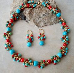 This is a statement necklace and earrings set. This statement necklace combines beautiful red coral and turquoise stones, with small clusters of red coral and turquoise natural stones. Great for the office or night out. This piece is finished with a simple lobster claw closure and has my signature logo tag and measures 16" in length, with 2 inches extension. This lovely pair of earrings features turquoise natural stone, which are accented with an ornate pewter bead cap, plated in 24 karat gold. This striking color combination is offset with beautiful clusters of red coral and turquoise stones. Hanging from a surgical steel lever-back, it measures 1.75" in length.  Also available in sterling silver plate. This necklace and earrings set ship in my blue gift box. Red Coral Jewellery, Jewelry Set Gold, Beautiful Beaded Necklaces, Summer Beach Jewelry, Choker Handmade, Blue Choker, Bonnet Crochet, Stone Jewellery, Cluster Necklace