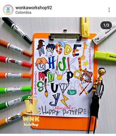 an orange clipboard with writing on it next to markers, pens and a toy