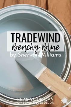 a paint can with a spatula in it and the words tradewind beachy blue