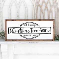 a wooden sign that says christmas tree farm