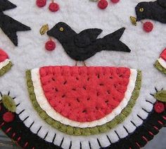 a piece of art made to look like a watermelon slice with birds on it