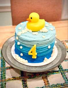 a birthday cake with a rubber ducky on top