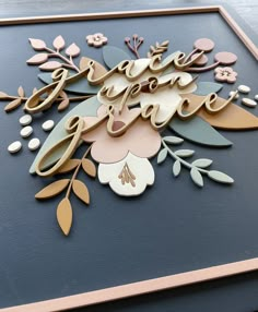 a wooden sign that says save the date with flowers and leaves