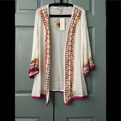 This Pretty Light Weight Cardigan Can Be Worn With A Favorite Blouse, Or With Your Bathing Suit. Material Is 100% Rayon. Spring Floral Embroidered Long Sleeve Cardigan, Embroidered Open Front Cardigan, Spring Casual Embroidered Cardigan, Casual Embroidered Spring Cardigan, Long Sleeve Cotton Cardigan With Floral Embroidery, Spring Floral Embroidery Open Front Cardigan, Summer Cotton Cardigan With Floral Embroidery, Casual Summer Cardigan With Floral Embroidery, Pink Floral Embroidery Cardigan For Spring