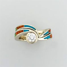 a gold ring with an orange, white and blue stripe around it's center