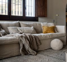 a living room filled with furniture and pillows