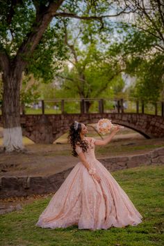 a woman in a pink dress is holding flowers