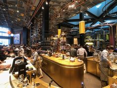 a group of people standing around a bar in a restaurant