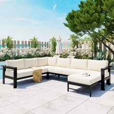 a large sectional sofa sitting on top of a white tile floor next to a pool