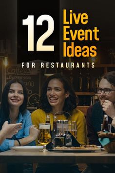 two women and one man sitting at a table with beer glasses in front of them