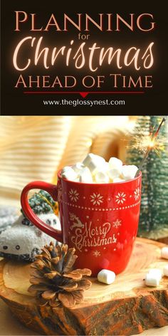 a red mug filled with marshmallows on top of a wooden table