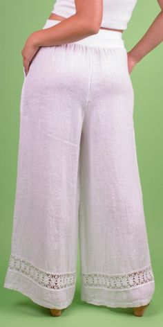 Linen Wide-Leg Pant with Front Pockets and Floral Lace Detail on Bottom Hem. Features a Stretchy Waistband for a Custom Fit. 100% Linen Model is 5'7 One Size Made in Italy White Linen Full-length Bottoms, Spring Capri Pants With Loosely Fitted Hips, Stretch Linen Full-length Bottoms, Stretch Linen Wide Leg Bottoms, Solid Color Relaxed Fit Capri Pants, Solid Capri Length Pants With Relaxed Fit, Relaxed Fit Solid Color Capri Pants, White Stretch Wide Leg Capris, Linen Bottoms In Capri Length For Spring