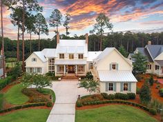 this is an aerial view of a house in the woods at sunset or sunrise time