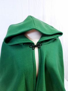 This short cloak is delightfully soft and comfortable. It's long enough to reach the back of the hand, keeping you warm but keeping your hands available when needed. It has a full hood and closes with your choice of a matching cloth frog clasp or a heart shaped metal clasp. Click through the pictures to see the options. This cloak is great for a costume piece or a cozy jacket, great for Spring, Fall, or over air conditioned buildings. Your cloak will measure about 30 inches in length. This listi Cozy Fitted Green Outerwear, Hooded Green Cape For Fall, Green Hooded Cape For Fall, One Size Outdoor Cape Outerwear, One Size Cape For Outdoor, One Size Outdoor Cape, Green Winter Cape Outerwear, Casual Hooded Winter Cape, Green Long Sleeve Winter Cape