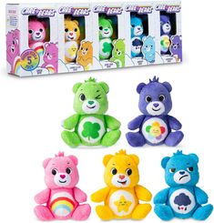 four different colored teddy bears sitting next to each other