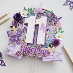 a birthday cake with butterflies and flowers on it