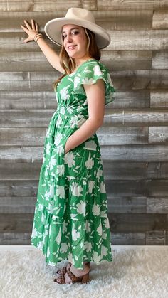 FINAL SALE this green and white floral dress from wishlist is giving me vacay vibes! perfect for a night out, sipping your favorite bev. it's also a lovely dress for a summer wedding or a bridal shower. a maxi dress with flutter sleeves, an elegant neckline, smocking at the waist and back, with a tiered skirt. it's lined and has pockets. you will look timeless in this dress. pair with some subtle jewelry and accessories and the perfect sandals to complete the look! our model is wearing a size sm