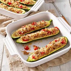 two pans filled with stuffed zucchini boats