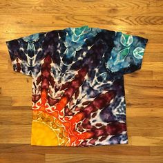 a tie dye t - shirt with an abstract design on it