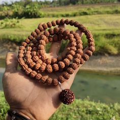 This Rudraksha necklace features 108 beads with a size of 8mm to 11mm. The pendant is made of genuine Jenitri Mukhi 8 Rudraksha. Perfect for meditation or as a spiritual accessory. Spiritual Mala With Round Beads For Yoga, Spiritual Yoga Mala With Round Beads, Spiritual Mala For Yoga With Round Beads, Spiritual 108 Beads Mala For Yoga, Ritual Amulet Mala With 8mm Beads, Traditional Mala For Meditation, Spiritual Round Mala For Meditation, Spiritual Mala For Meditation, Holistic Mala For Meditation Festivals