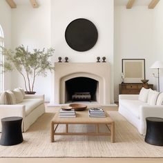 a living room filled with furniture and a fire place in the middle of a room