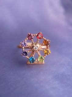 Ferris Wheel Ring lovingly designed by Love Estella Jewelry. All original designs - conceptualized, drawn and crafted by our team. Happy sparkly colours to make your day! Set in Garnet, Citrine, Peridot, London Blue Topaz, Iolite, Tanzanite & Tourmaline. Material: Sterling 925 Silver plated 18k Gold. Size: Adjustable Band fits US5-US10 (Fits super comfortably like a fixed ring size). Three hardware available - Rose Gold, Silver & Yellow Gold. Rainbow Ring, Rainbow Rings, Natural Gemstone Ring, Natural Gemstone Jewelry, Jewelry Lookbook, Girly Jewelry, London Blue Topaz, Jewelry Inspo, Dream Jewelry