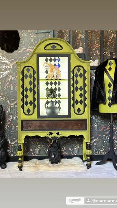 a yellow and black cabinet sitting in front of a wall