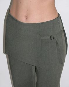 Archive Pants in Dark GreyPaloma Wool women's mid-rise skirt pants in brown. These pants feature an attached mini-skirt that overlaps the straight leg bottoms underneath.FEATURES  Side concealed zip closure  Overlapping skirt with tie closure  Straight leg  Mid-rise  Materials: 53% recycled polyester, 43% mulesing free wool, 4% elastane  Made in Spain Pants With Attached Skirt, Paloma Wool Pants, Pants With Buttons On Side, Pant Skirt Outfit, Skirt Pants Outfit, Skirt Over Pants Outfits, Skirt Over Trousers, Skirts Over Pants, Tie Up Pants