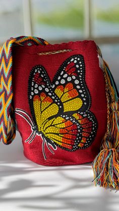 a red purse with a yellow butterfly on it