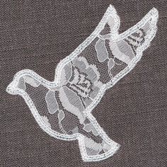 an embroidered bird is shown on the back of a shirt that has white thread and sequins