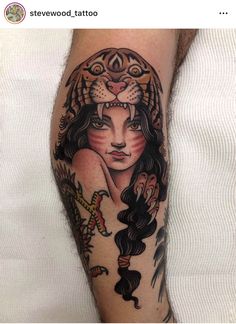 a woman with a lion head tattoo on her arm