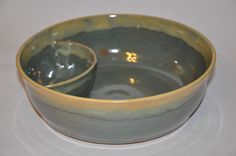 two bowls sitting side by side on top of a white tableclothed countertop