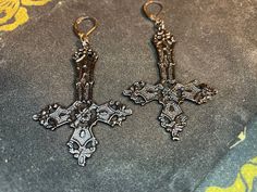 Dark times call for Darkness Jewelry. This custom handmade pair of Upside-Down Cross Inverted Crucifix earrings is truly a sight to behold! Made of solid, hand-poured aluminum with a powder-coated black color. Show your support of The One behind all of this madness and be saved when He sets foot upon the land. Material: Aluminum, Stainless Steel Color: Black Dimensions: Earring Pendant height = 53 millimeters, Pendant width = 32 millimeters Designed in the USA and hand-made in THAILAND! Black Fantasy Style Pierced Earrings, Black Fantasy Earrings, Black Fantasy Style Earrings, Black Gothic Cross Earrings, Upside Down Cross, Wiccan Jewelry, Cross Earrings, Gorgeous Earrings, Pendant Earrings