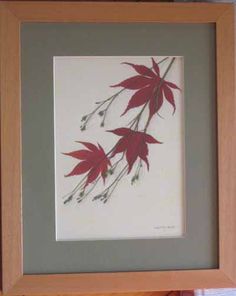 a painting with red leaves in a wooden frame