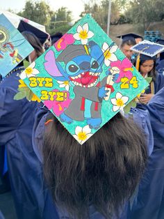 a group of people in graduation gowns and caps with stitched hats on their heads