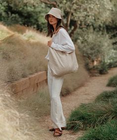 Linen Bucket Hat Natural Inspired by fisherman styles, our elevated take on the classic bucket hat is the summer’s definitive beach bag essential. 100% linen. Made in Portugal. | Jenni Kayne Women's Linen Bucket Hat Size Medium/Large Summer Outfits Bucket Hat, Fisher Hat Outfit, Linen Bucket Hat, Eco-friendly Summer Bucket Bag For Everyday, Beige Canvas Bucket Hat For Summer, Lightweight Natural Bucket Hat For Travel, Summer Beige Canvas Bucket Hat, Natural Lightweight Bucket Hat For Travel, Casual Linen Hats For Vacation