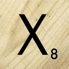 a wooden sign with the letter x on it's front and back sides in black