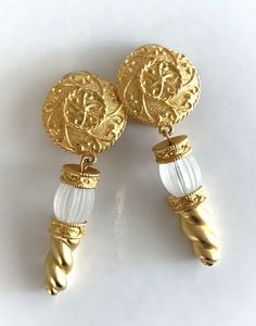 "Engraved Satin Gold Tone Drop Clip On Earrings with Ribbed Frosted White Glass Beads Textured Round Tops are Embossed and Finished with Foxtail Edge Satin Gold Engraved Rondelles Dangle with Frosted White Ribbed Glass Beads and Gold Rope Ends Earrings Measure 2 3/4\" Long  Slightly Domed Round Tops Measure 1\" in Diameter Cushion Back Clip On Earrings Earring Pair Weighs 45 Grams Unsigned Jose Barrera These Earrings are New Vintage From the 1990's Made in USA COMPLIMENTARY DOMESTIC SHIPPING" Elegant Beaded Clip-on Earrings For Formal Occasions, Gold Beaded Costume Jewelry Earrings, Gold Engraving, New Vintage, Frosted Glass, White Glass, Clip On Earrings, Gold Tones, Jewelry Earrings Dangle